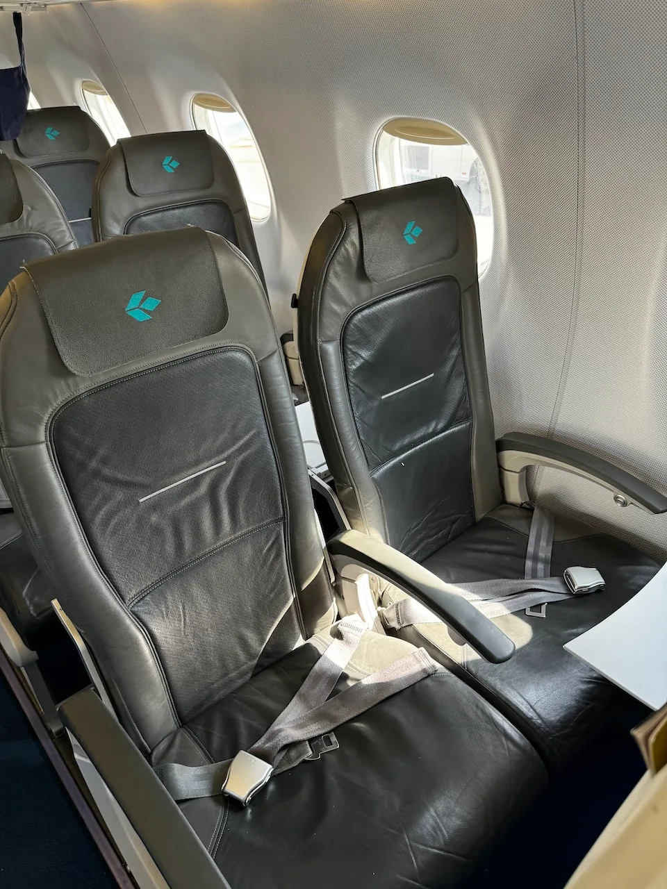 Business Class-Sitz im Flugzeug mit Kopfstütze und Sicherheitsgurt