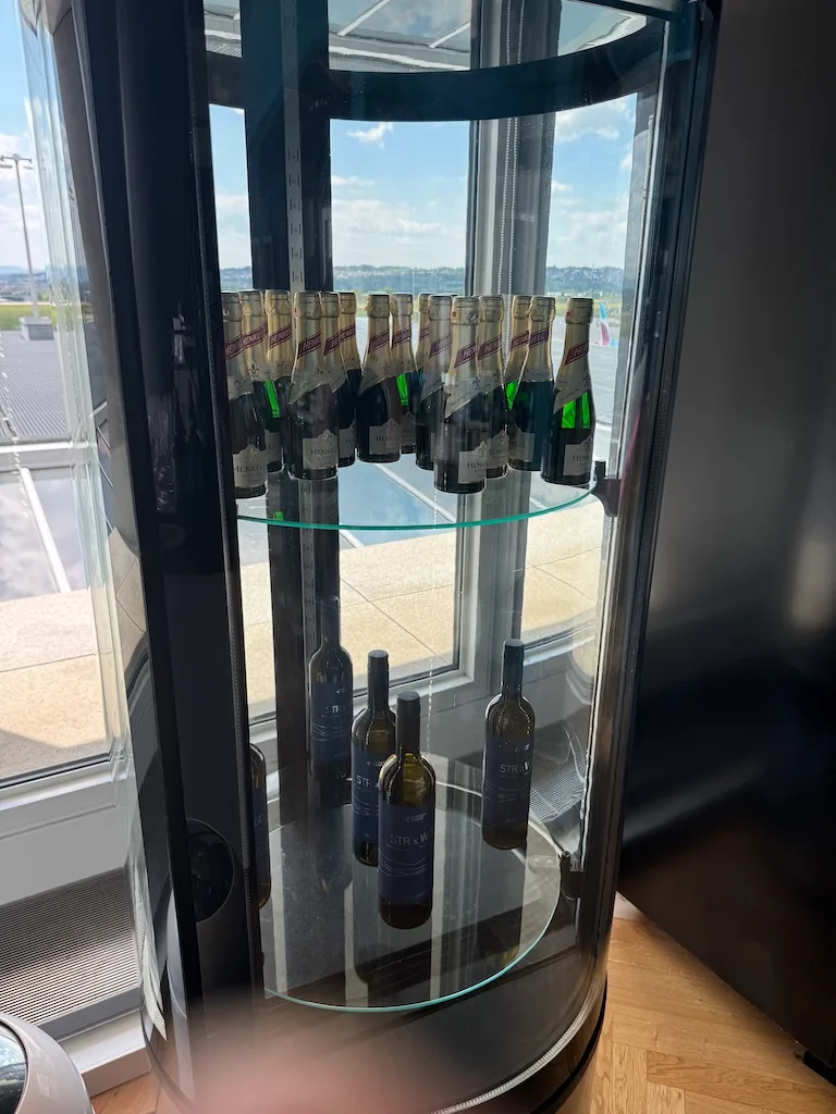 Glasvitrine mit Weinflaschen im Flughafenlounge