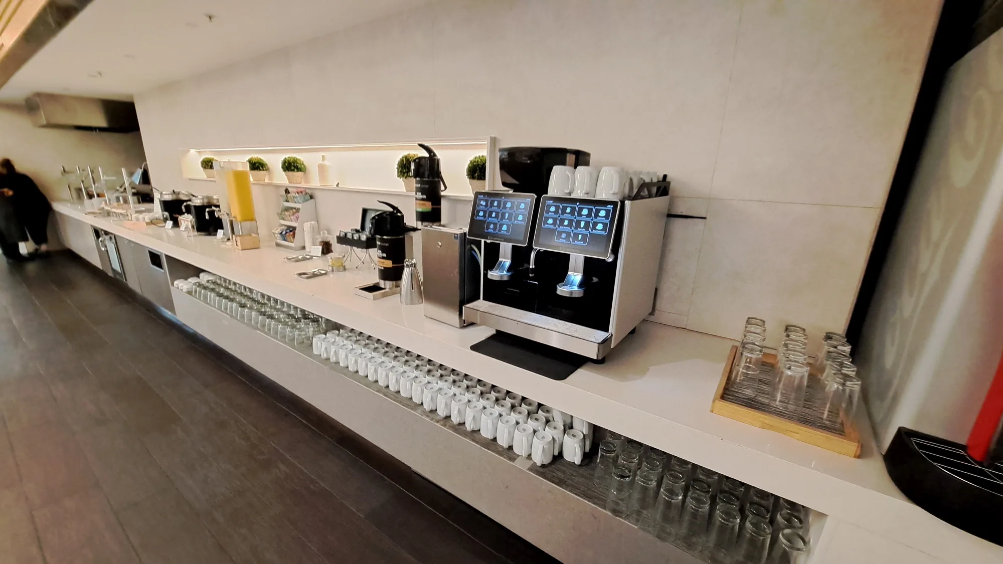 Kaffeebar mit Kaffeemaschine und Gläsern auf weißer Theke