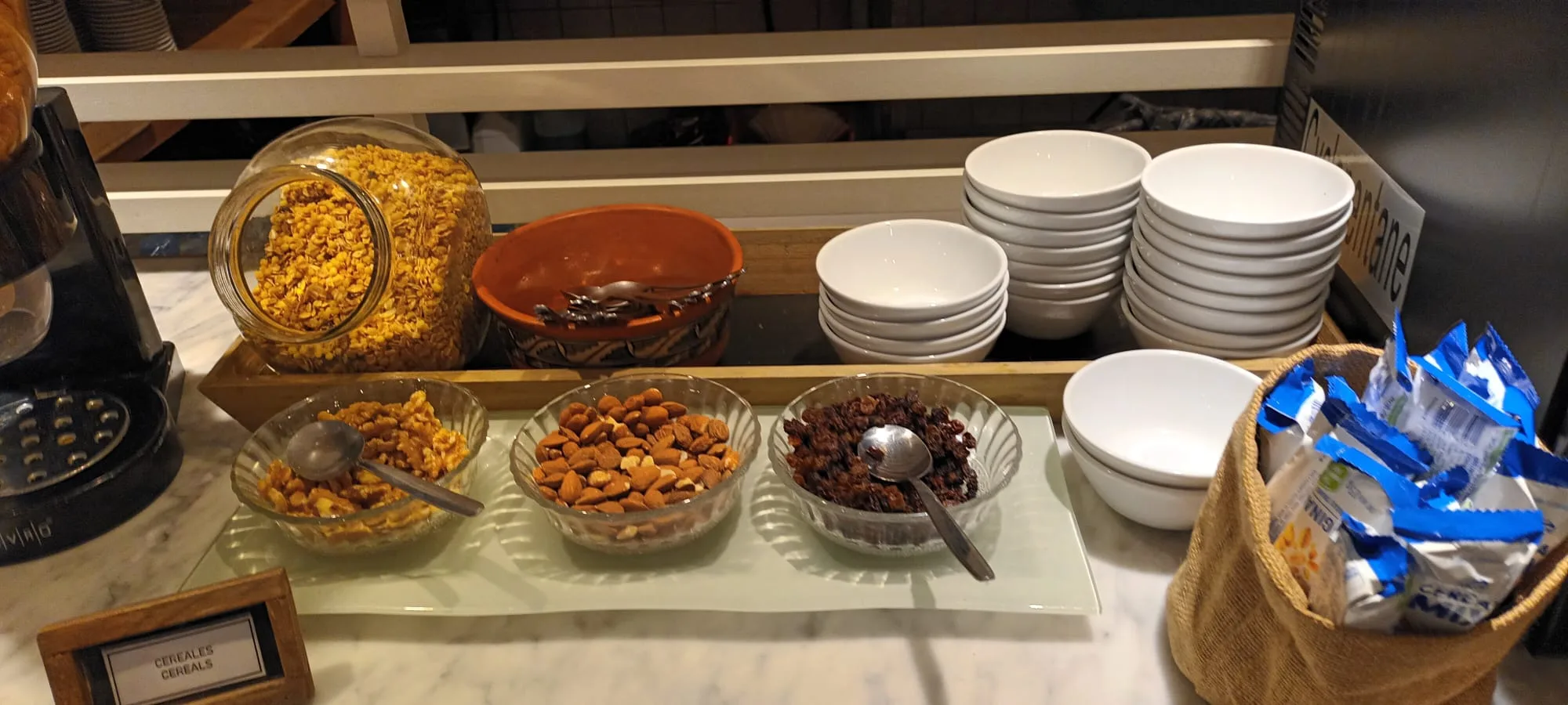 Frühstücksmüslibuffet mit Cornflakes, Mandeln und getrockneten Früchten