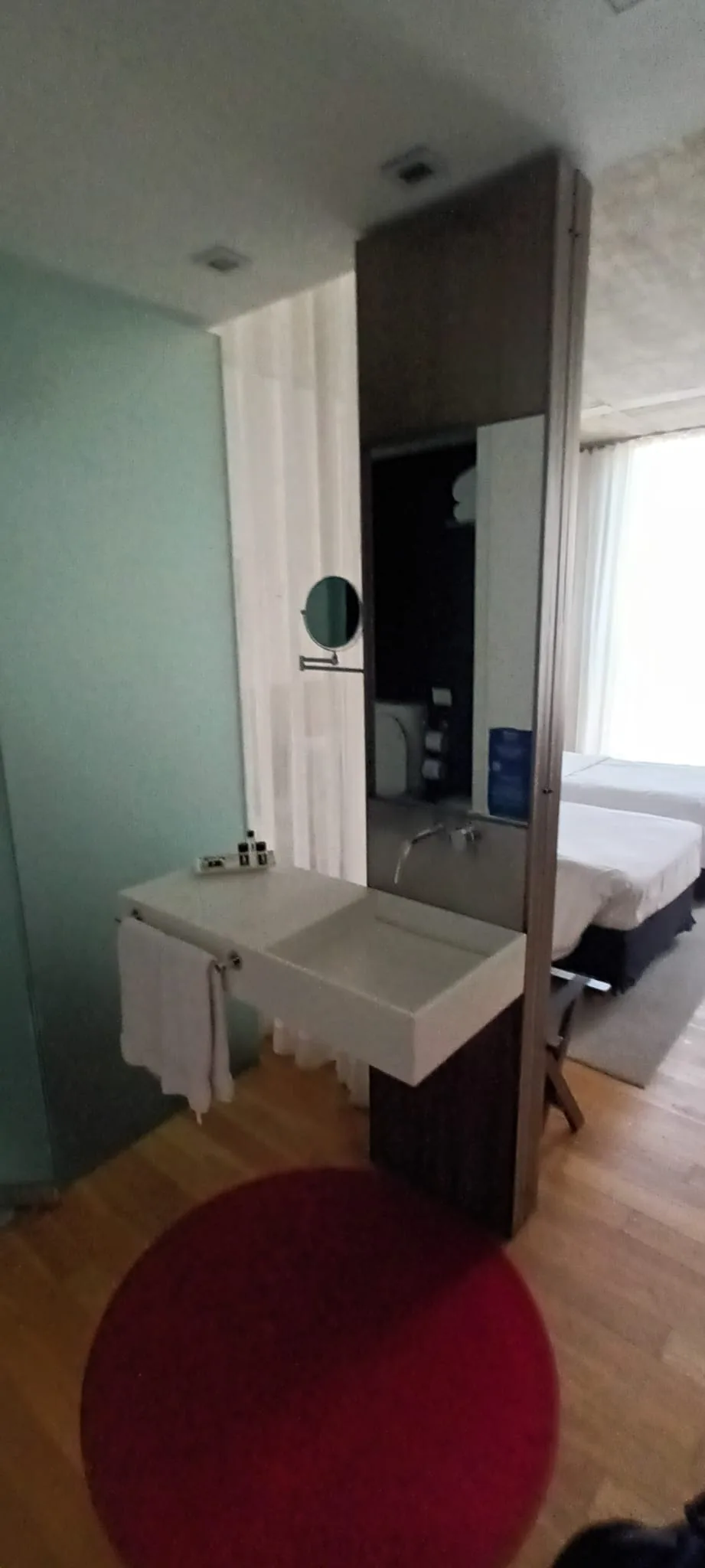 Hotelzimmer mit Doppelbett und Tagesdecke in Grautönen