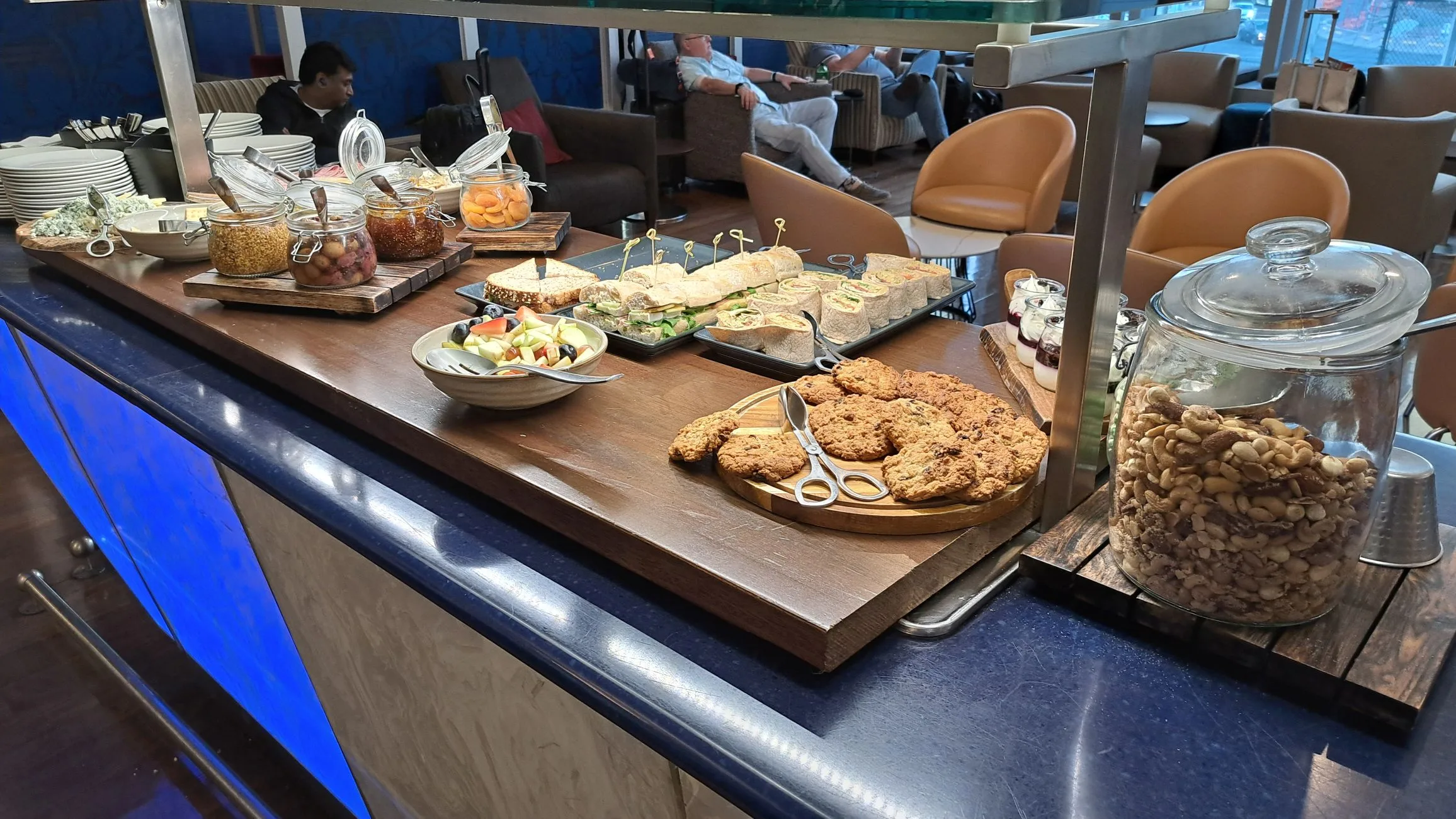 Buffet mit Sandwiches, Keksen und Snacks auf Holzbrettern