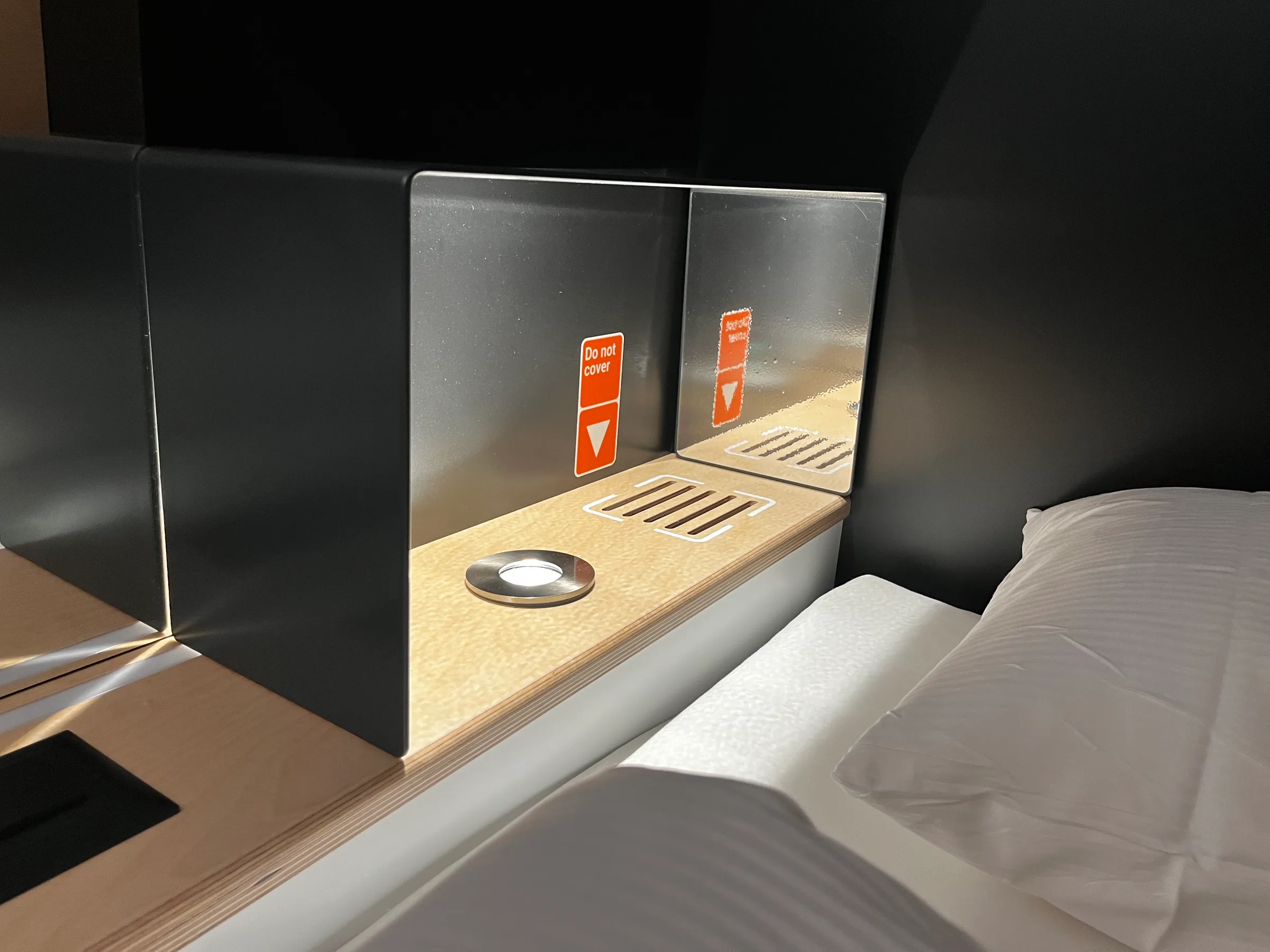 Hotelzimmer mit Doppelbett und Fenster mit Hinweisschildern