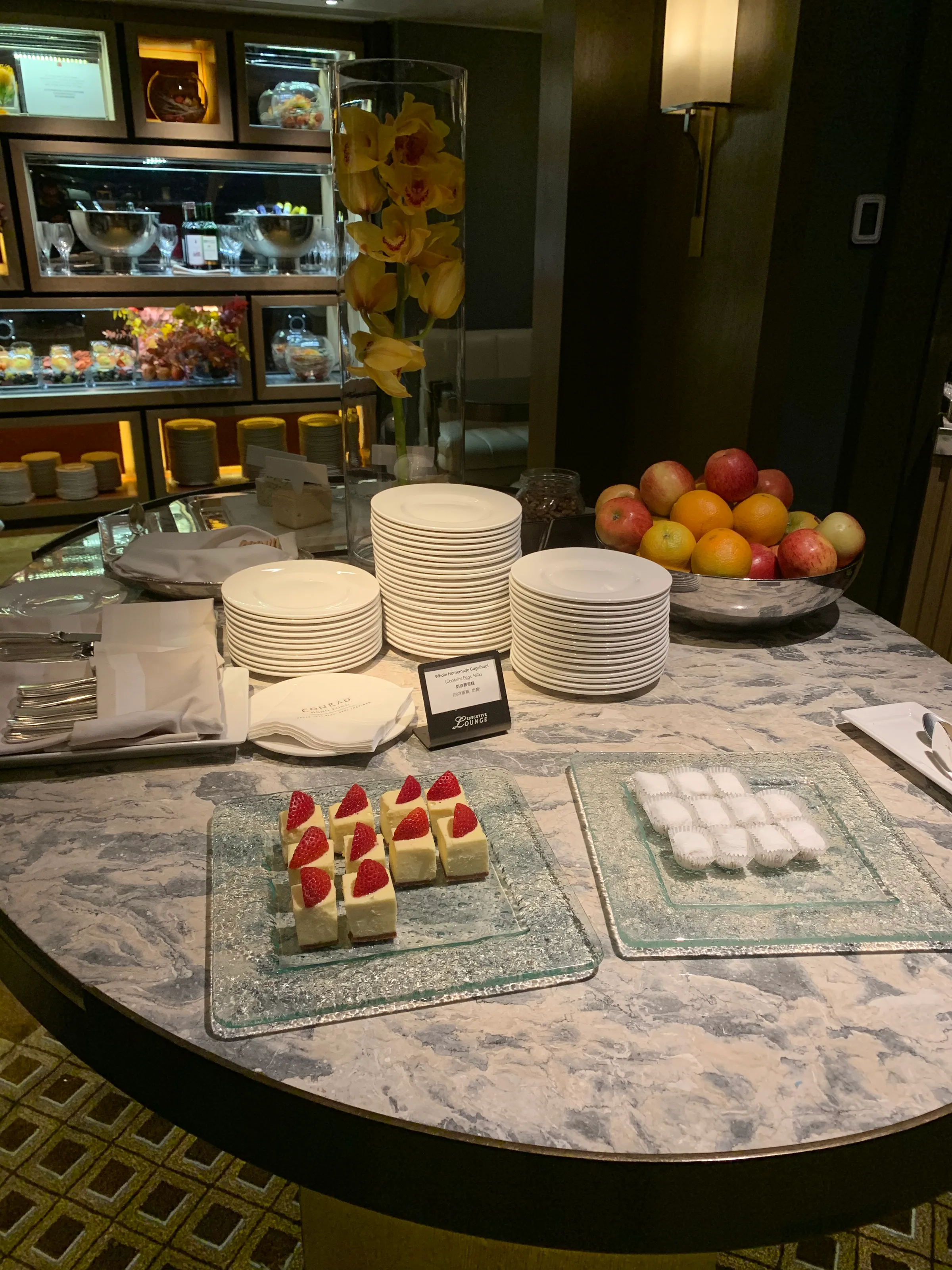 Frühstückstisch mit Obstschalen, Desserts und Geschirr im Hotel