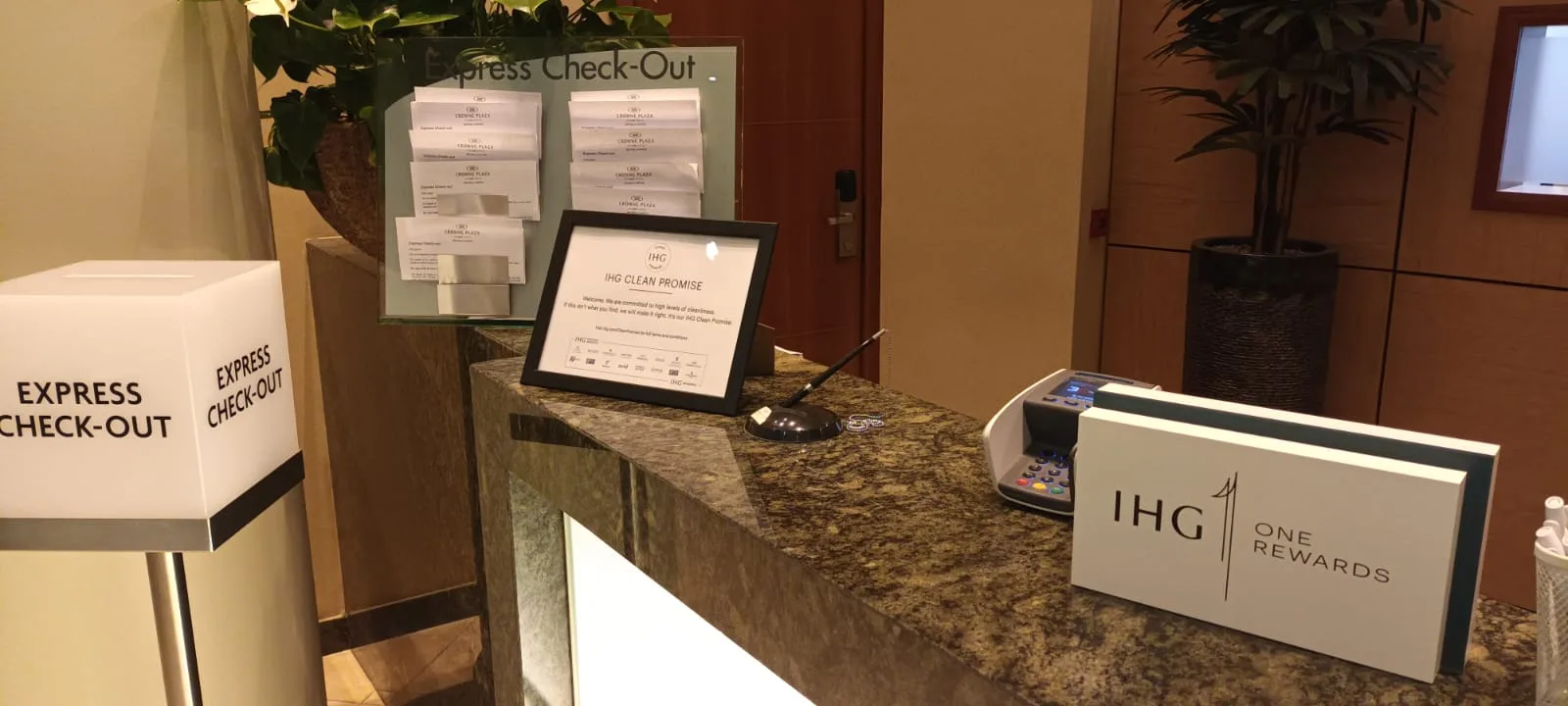 Hotelcheck-out-Desk mit Schildern und Pflanzen