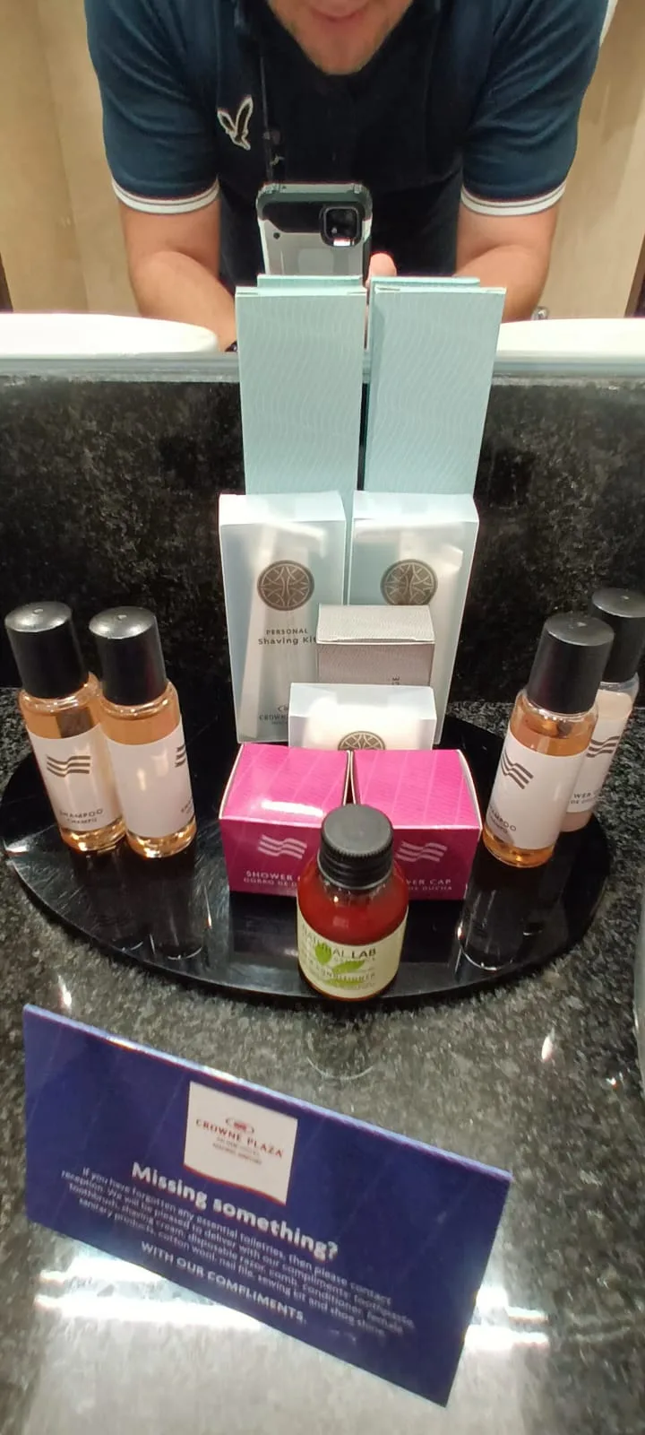 Hotelzubehör auf Tablett mit Shampoo, Seife und anderen Produkten