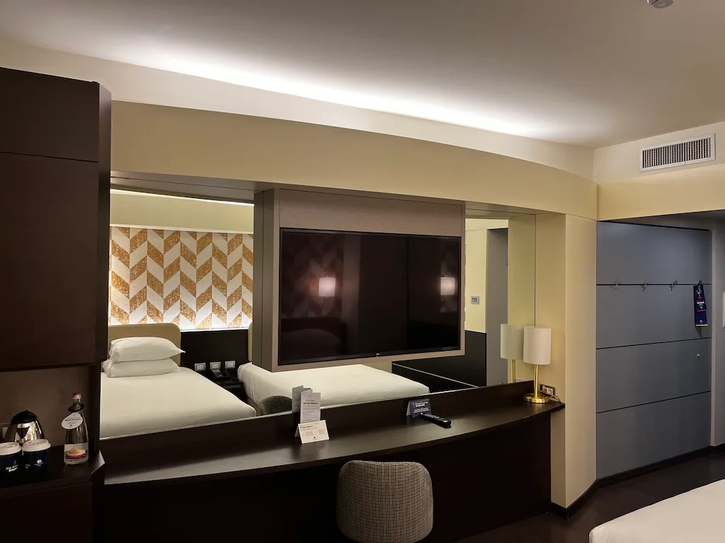 Hotelzimmer mit Doppelbett und Spiegel im modernen Design
