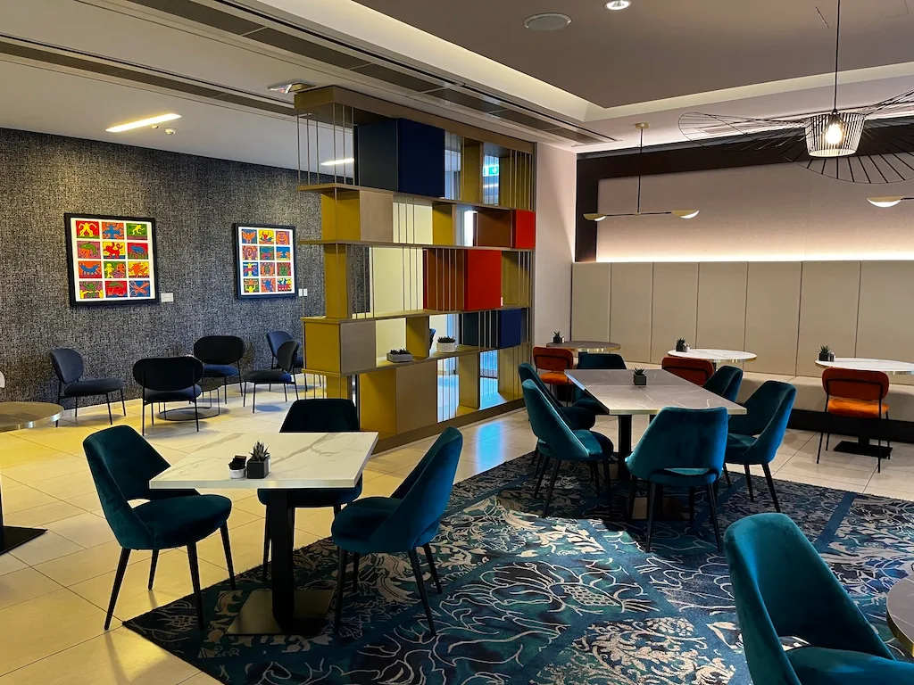 Lounge mit buntem Regal und gemütlichen Stühlen