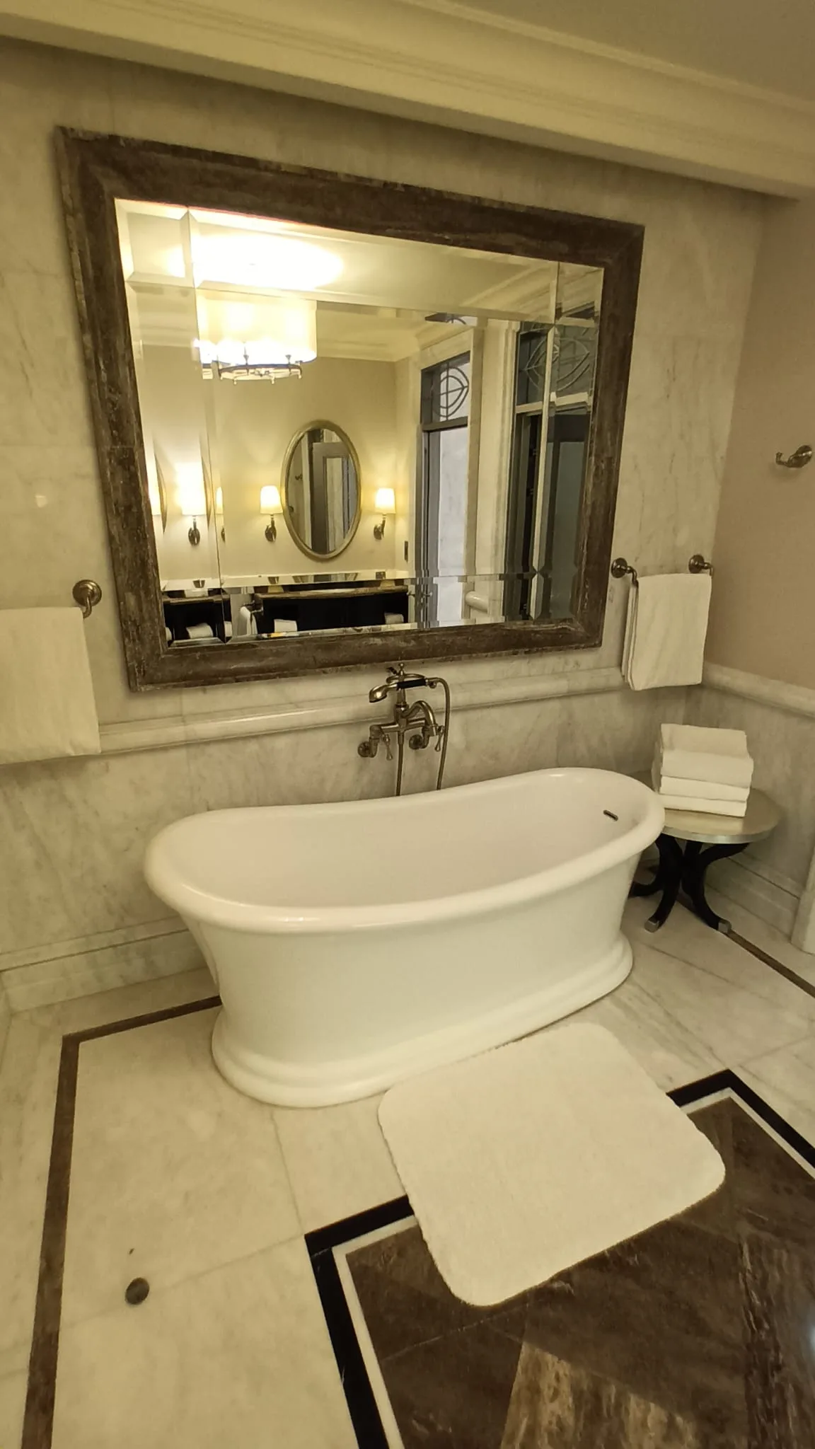 Freistehende Badewanne mit Spiegel und Handtuchhalter
