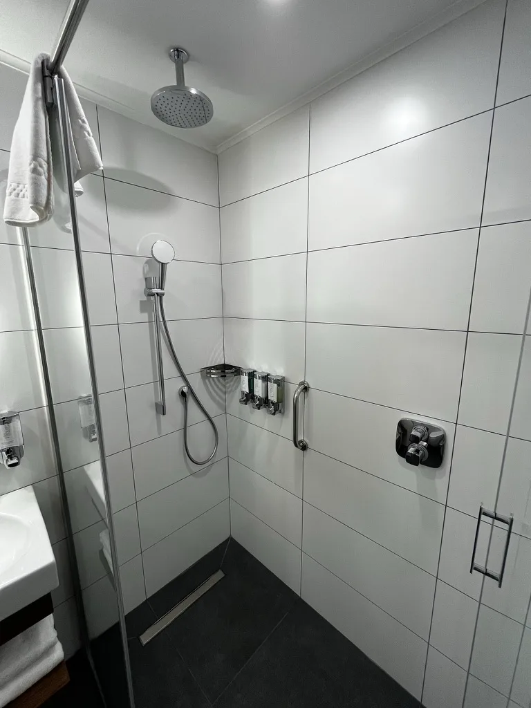 Duschbereich mit Regendusche und Handbrause im Hotel