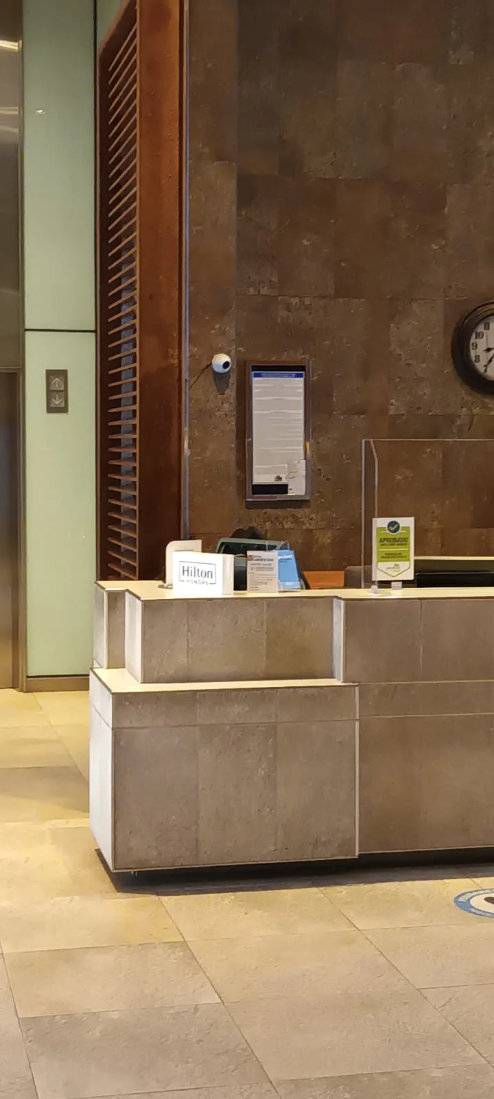 Rezeption des Hilton Garden Inn mit Informationsmaterialien und Uhr