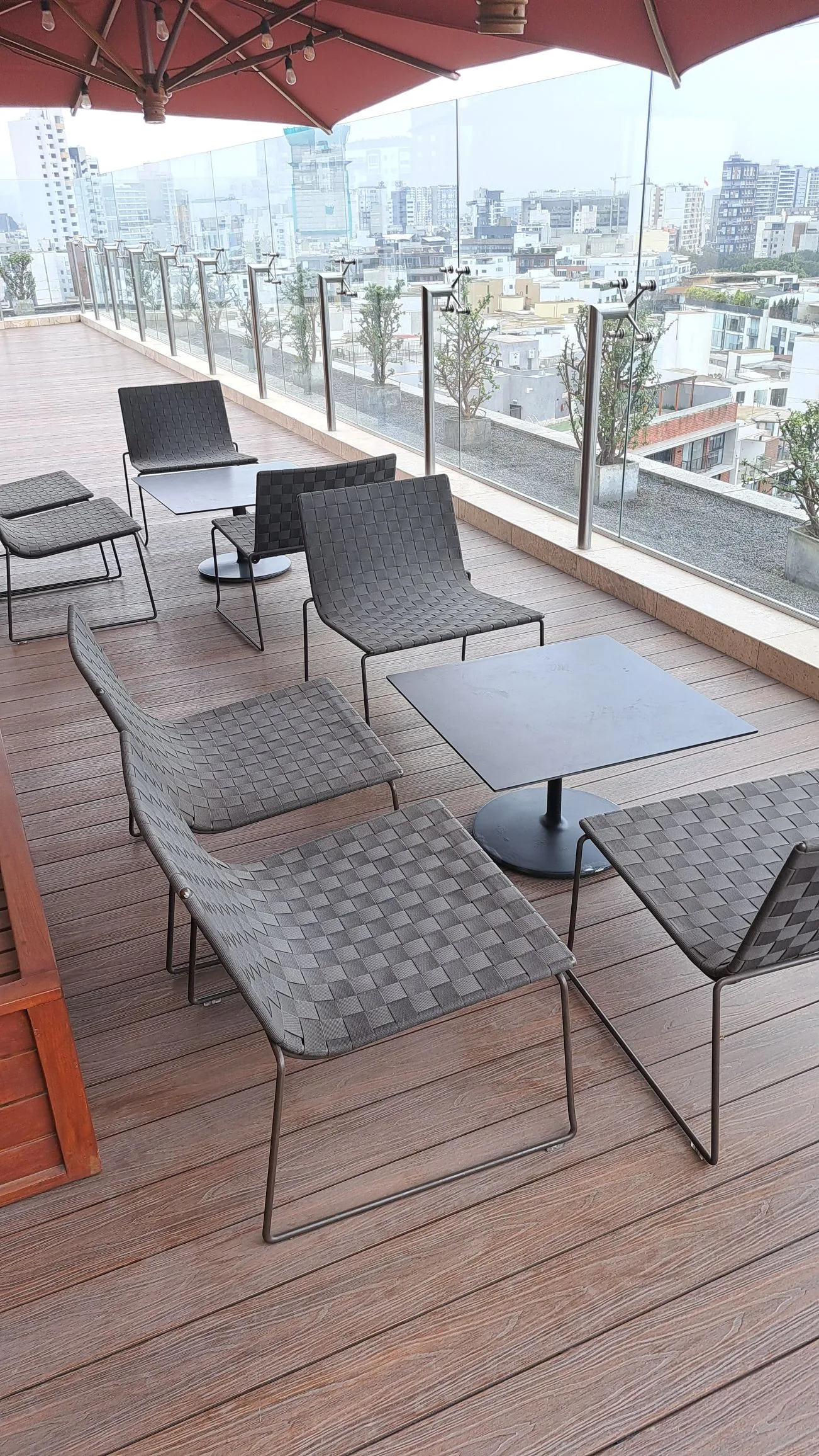 Terrasse mit Stühlen und Tischen auf Holzboden