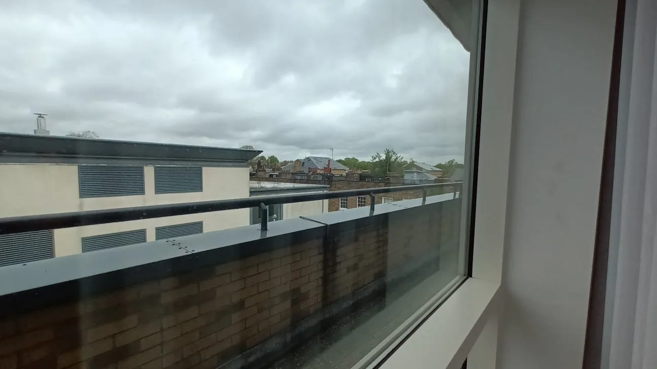 Hotelterrasse mit Blick auf benachbarte Gebäude am bewölkten Tag
