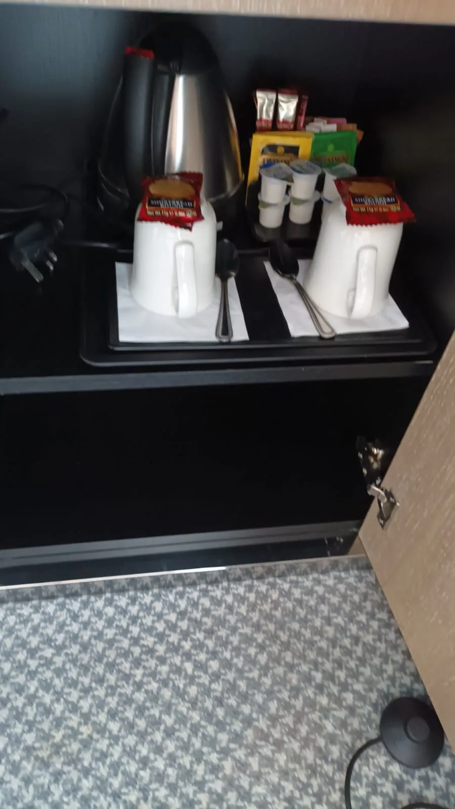 Kaffeemaschine und Tassen auf Tablett im Hotelzimmer