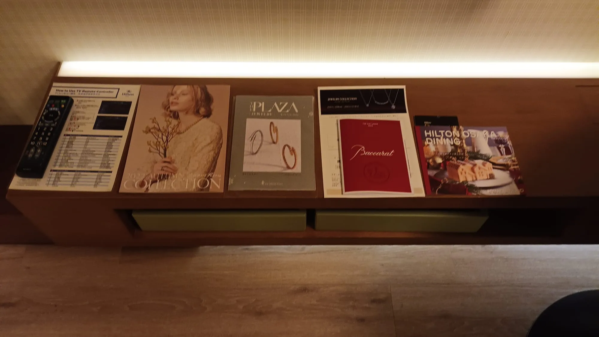 Hotelzimmer mit Werbeprospekten und Fernbedienung