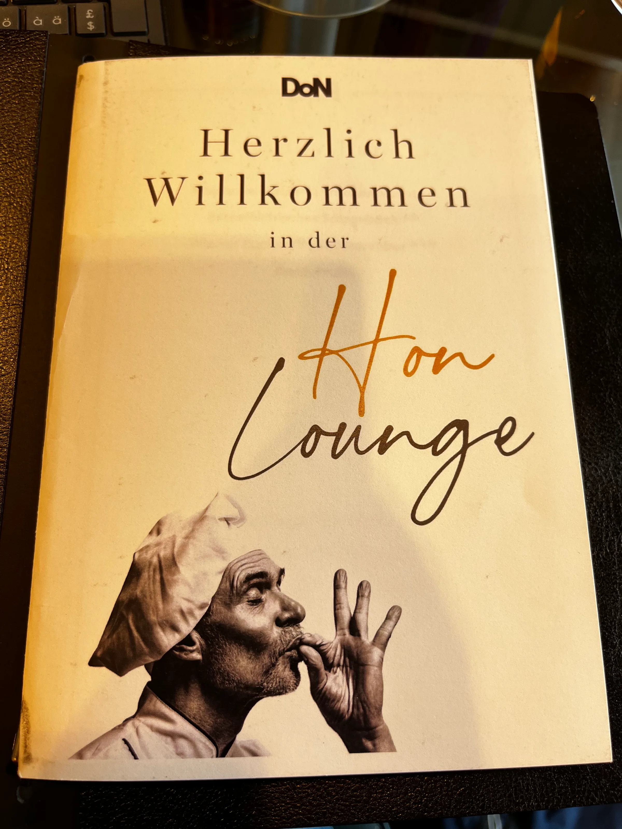 Willkommensschild mit Koch in der Hon Lounge