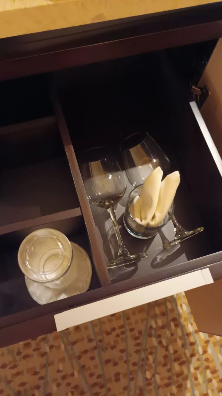 Hotelzimmer mit Gläsern und Snacks im Schublade