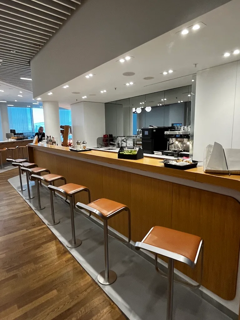 Lounge-Bar mit Stühlen und Kaffeevollautomaten
