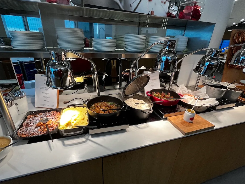 Buffet mit verschiedenen Gerichten und Kochtopf auf dem Tisch
