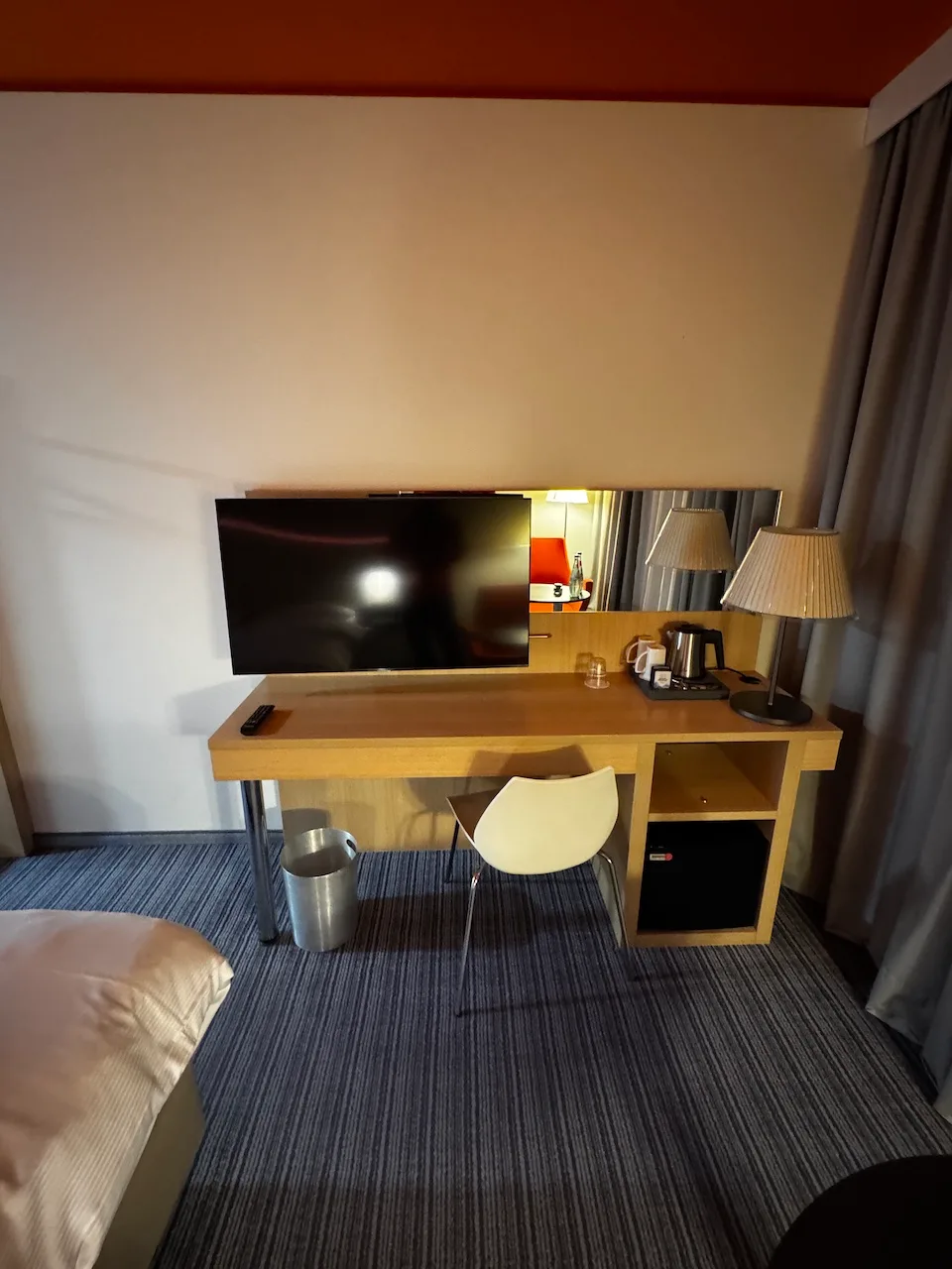 Hotelzimmer mit Schreibtisch, Fernseher und Kaffeemaschine