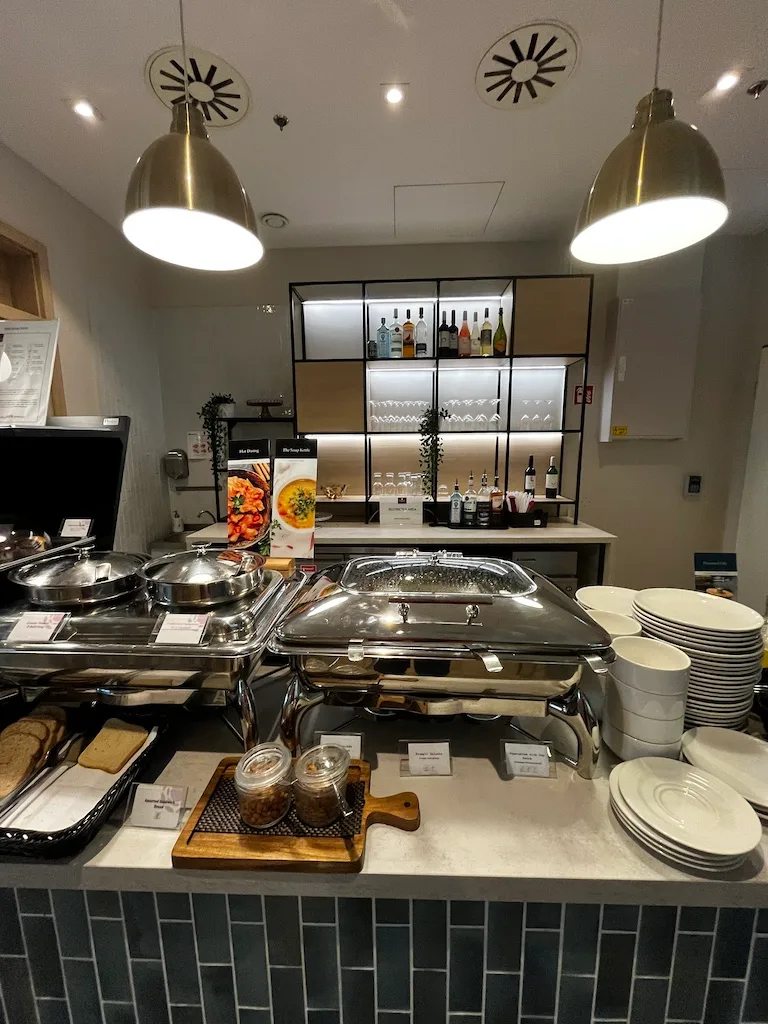 Buffet mit warmen Gerichten und Kaffeeautomat in einem Loungebereich