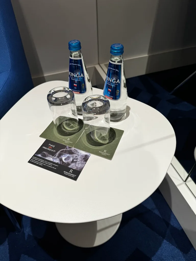 Tisch mit Mineralwasserflaschen und Gläsern auf Untersetzer