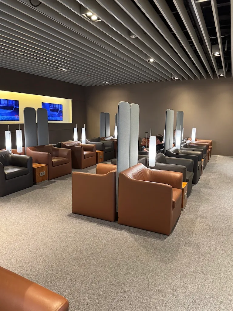 Lounge mit Sesseln und Trennwänden aus Stoff