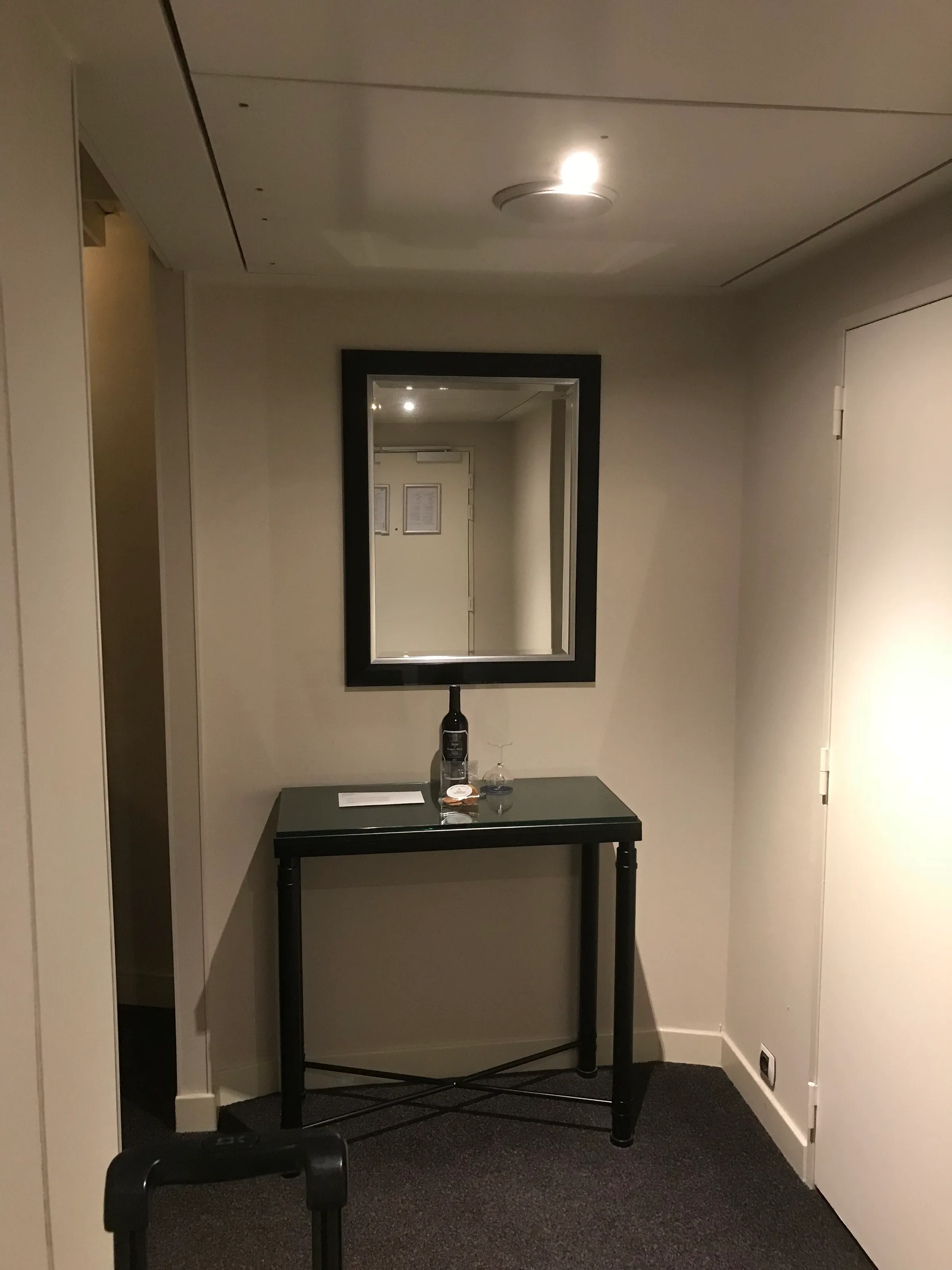 Hotelzimmer mit Spiegel und Tisch