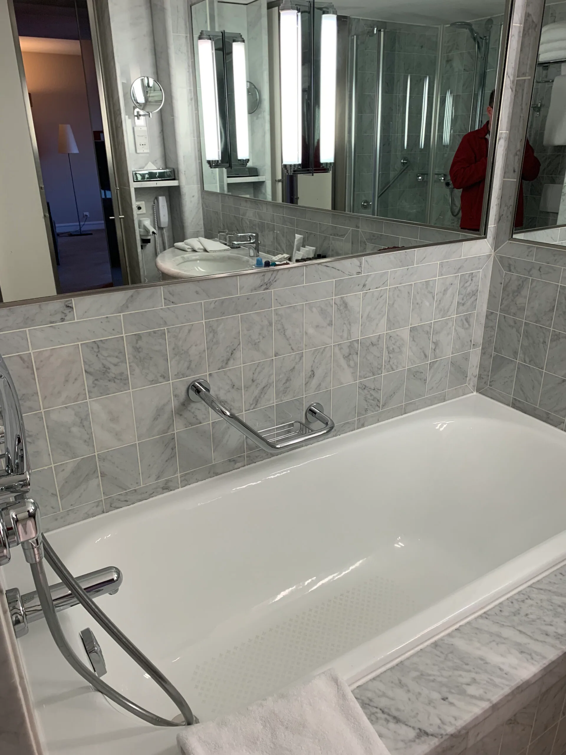 Gelbes Sofa mit Kissen vor blauem Teppich im Hotelzimmer