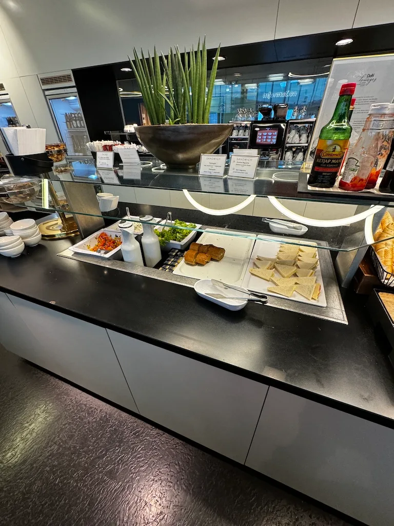 Buffet mit Sandwiches und Salat auf einer Lounge im Flughafen Wien