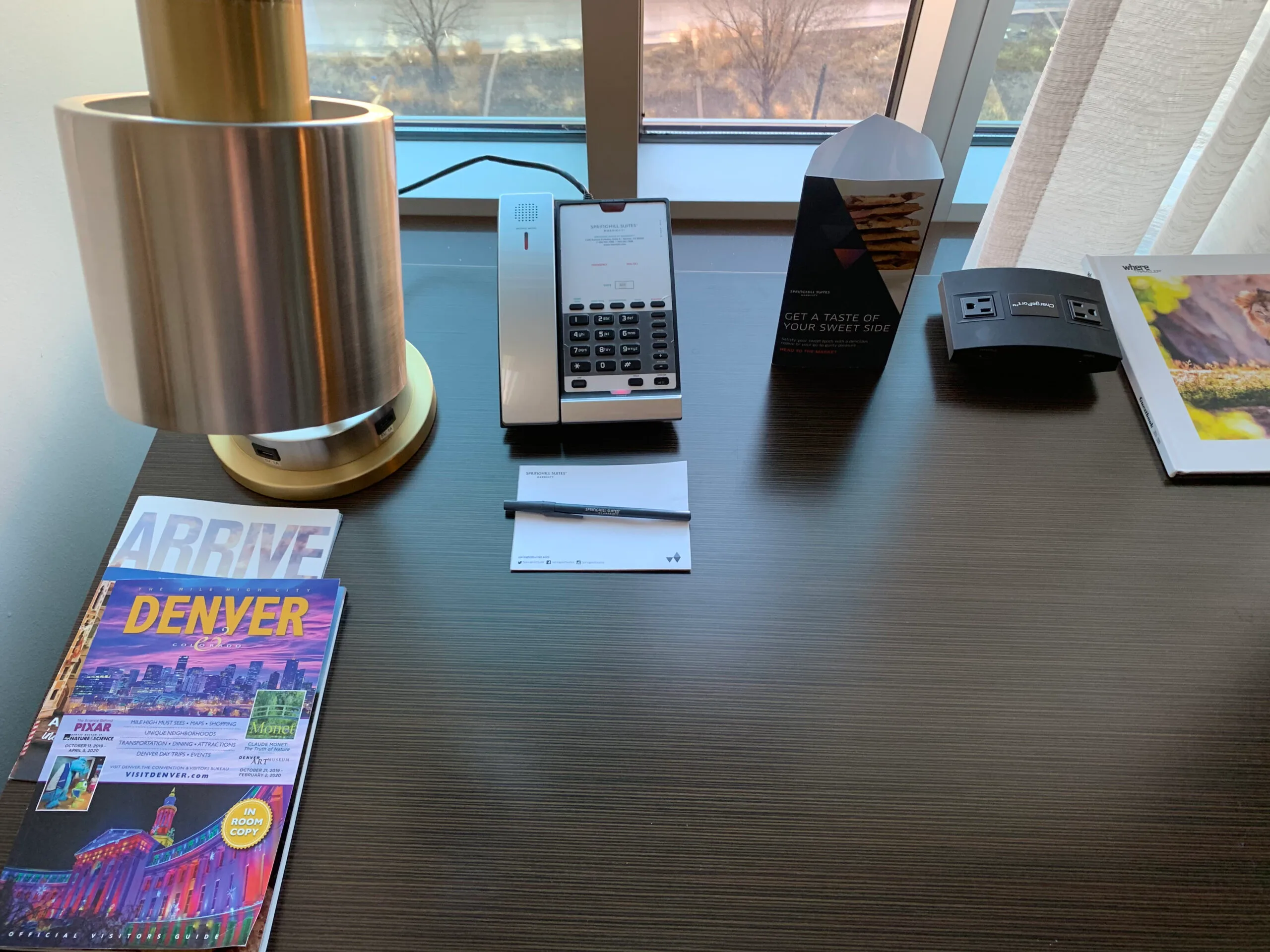 Hotelzimmer mit Telefon und Notizblock auf Schreibtisch