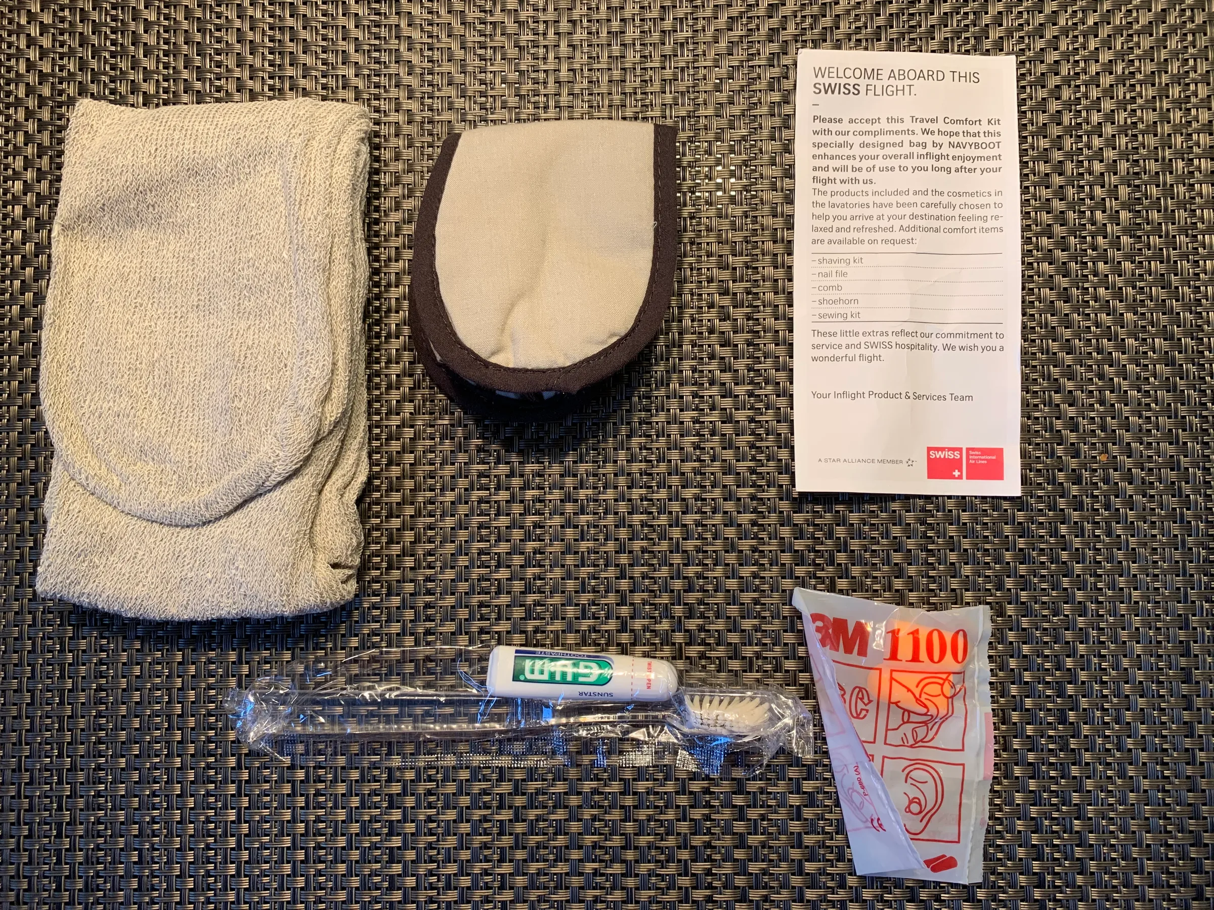 Inhalt des Kits: Handtuch, Zahnbürste und Pflegeprodukte