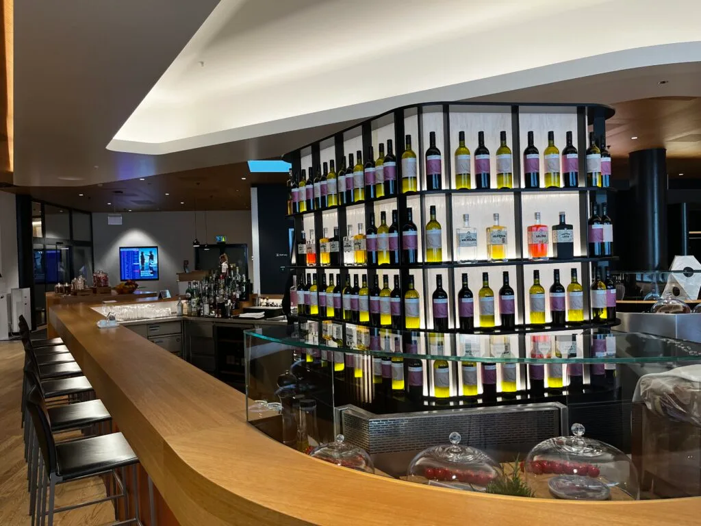 Bar mit Flaschenregal voller Weinflaschen im First Class Lounge
