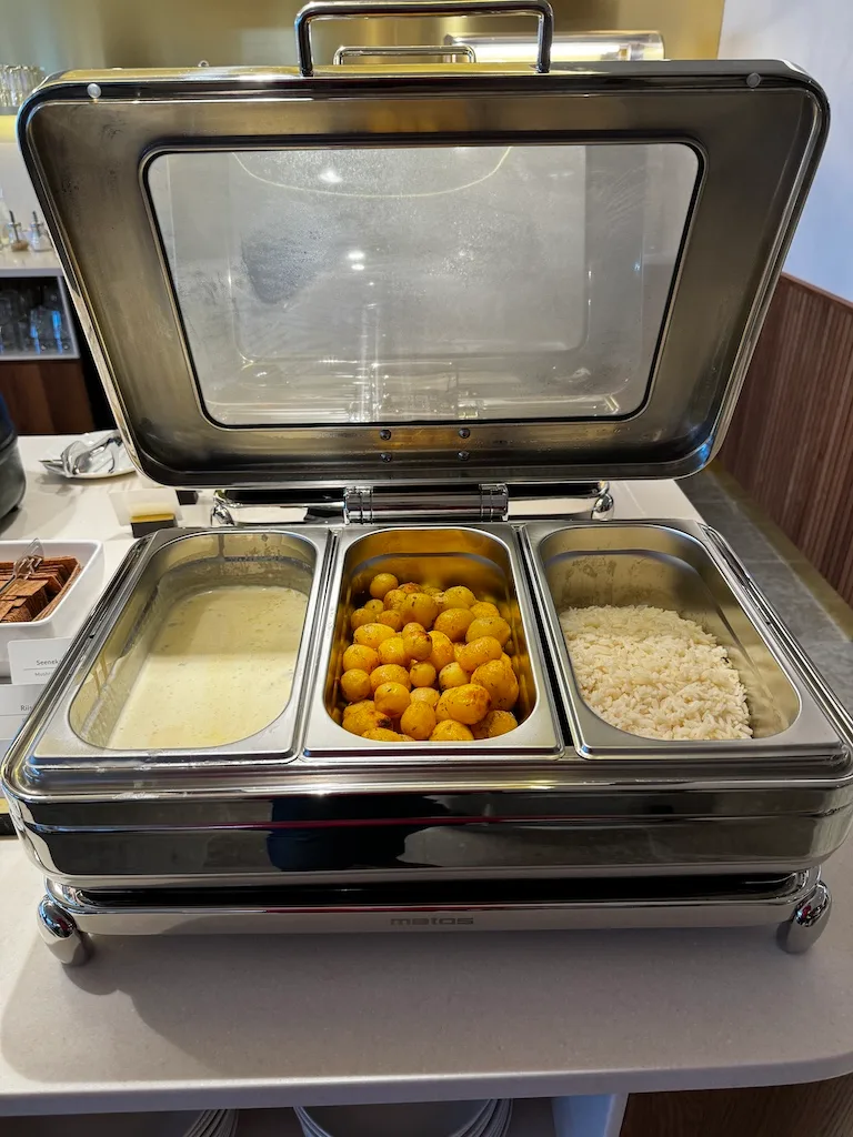 Buffet mit drei Schalen: Sauce, gebratene Kugeln und Reis