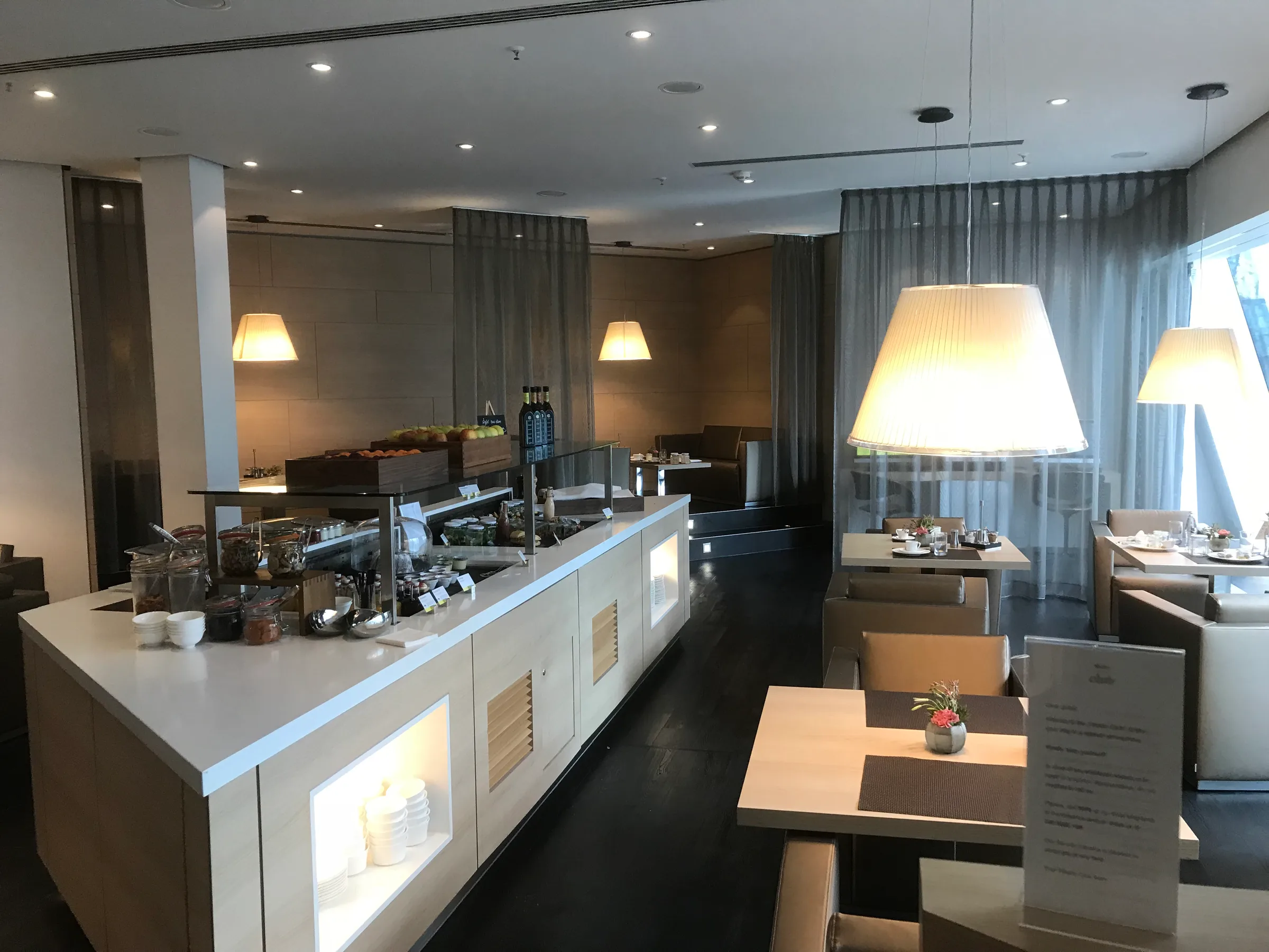 Frühstücksbuffet im Hotel mit Tischen und Lampen