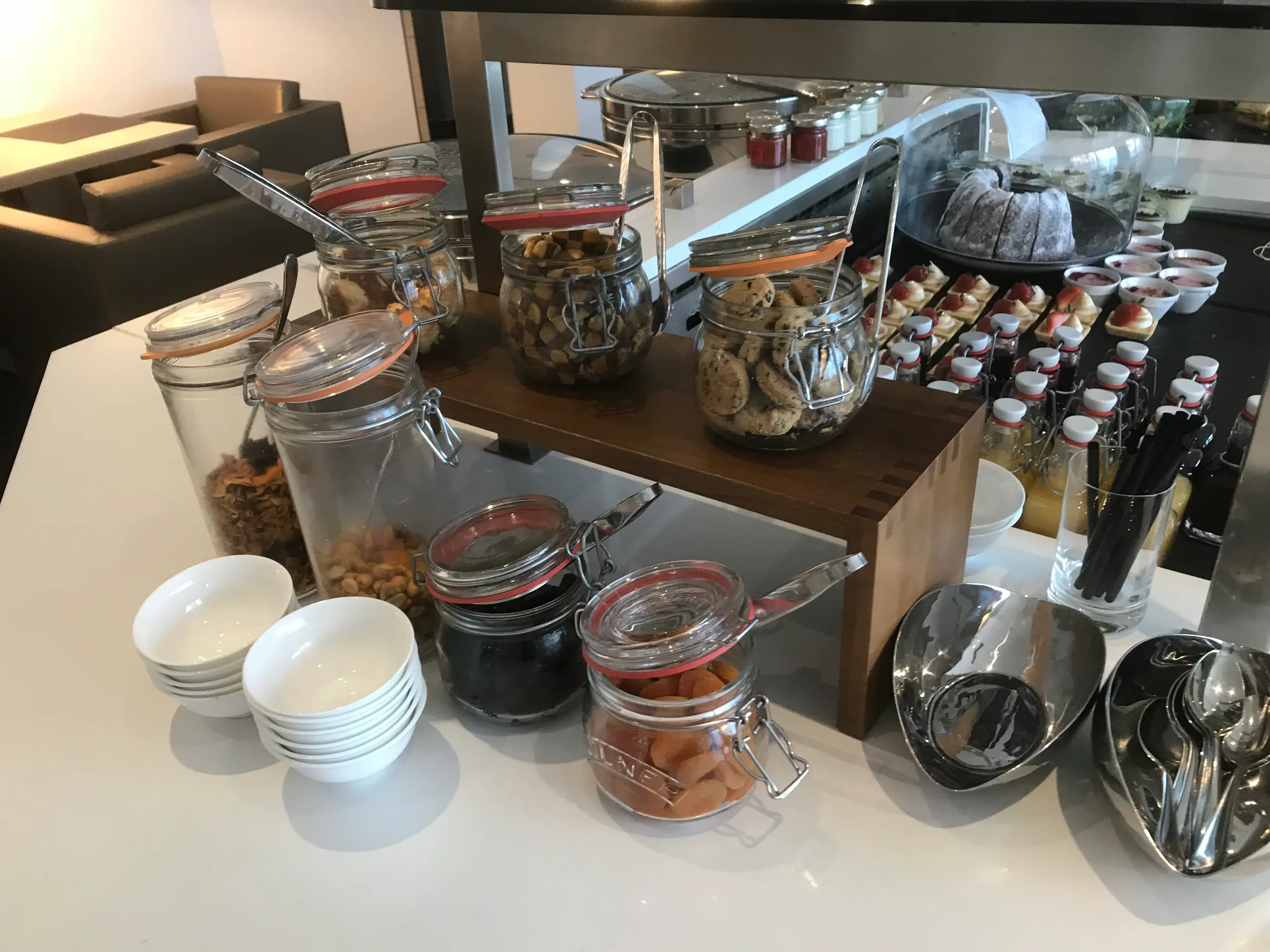 Frühstücksservice mit Keksen, Nüssen und Fruchtaufstrichen in Gläsern