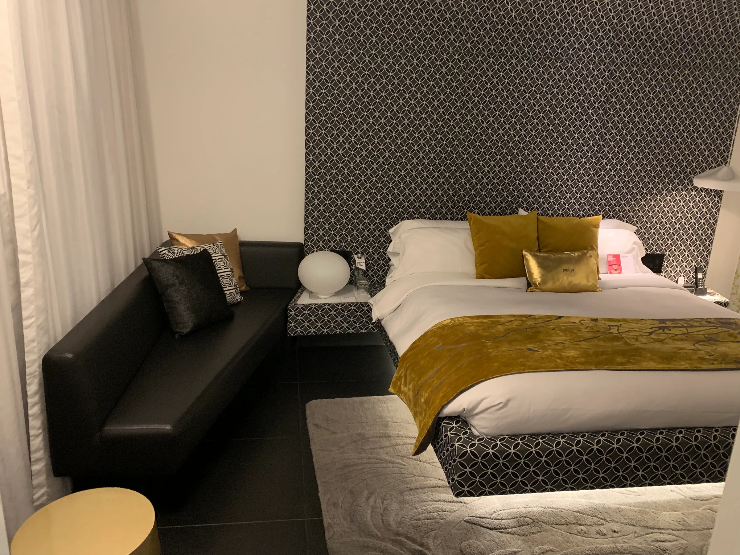Hotelzimmer mit Doppelbett und dekorativer Tapete
