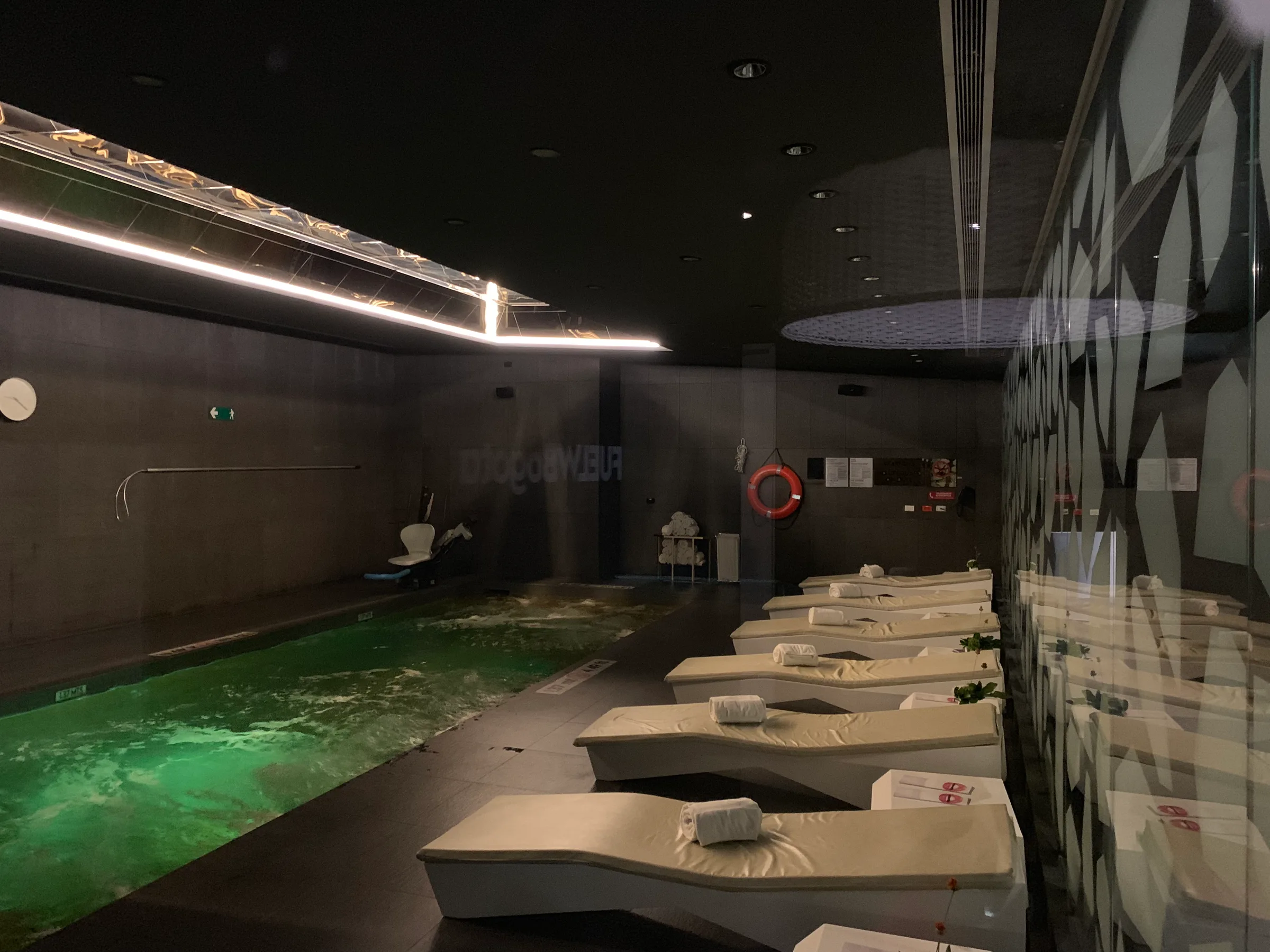 Innenraum eines Wellnessbereichs mit Whirlpool und Liegen