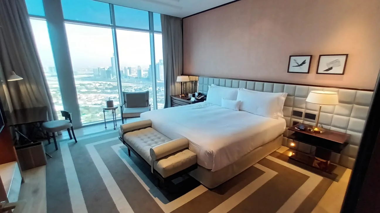 Schlafzimmer mit Doppelbett und Blick auf die Stadt